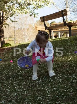 Toddler on easter egg hunt Stock Photos