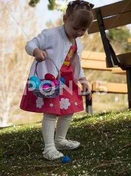 Toddler on easter egg hunt Stock Photos