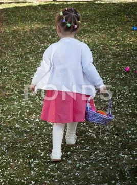 Toddler on easter egg hunt Stock Photos