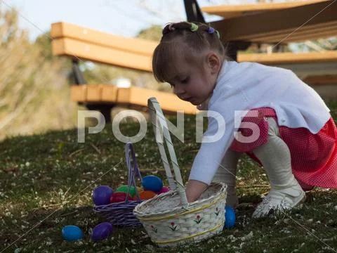 Toddler on easter egg hunt Stock Photos