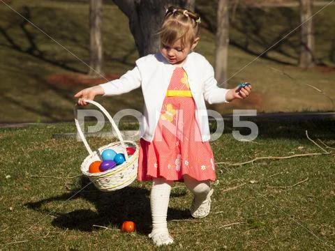 Toddler on easter egg hunt Stock Photos