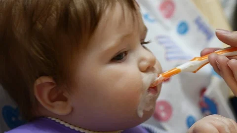 A Toddler Eats With A Spoon. 스톡 동영상 105973832