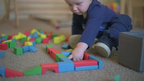 Toddler Exploring Building Blocks toddler curiously pointing at colorful wooden Видео 296089016