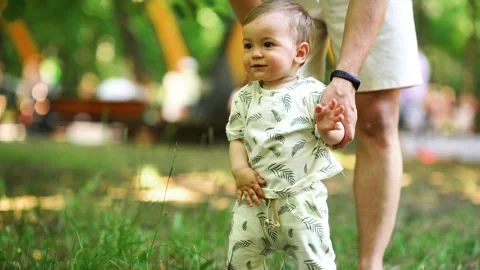 The toddler is exploring the world, still gaining his footing. Stock Footage 279055081