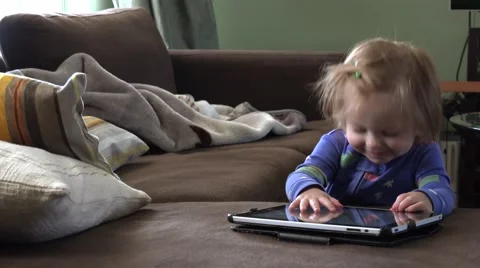 Toddler Gets Distracted From Tablet Computer In Blue Pajamas. DENVER, COLORADO Video stock 60633494