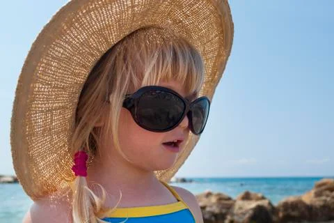 Toddler girl looks in Audrey Hepburn - style glasses Stock Photos