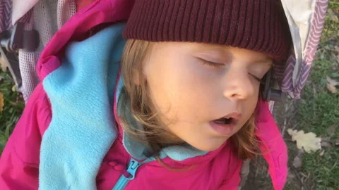 Toddler girl sleeping in stroller on a cold day, 4k slow motion video Stock Footage