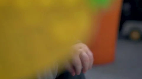 Toddler Hands Holding Pineapple Sensory Toy And Green Memory Game Card Stock Footage 330708331
