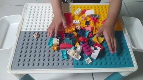 Toddler Hands Playing and Building with Colorful Blocks 4k Vídeos de archivo 337777142