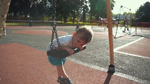 Toddler  having fun on the swing Stock Footage 79976273