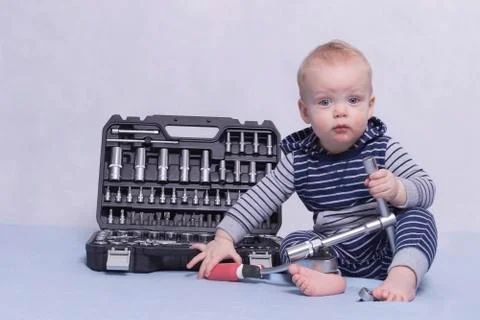 Toddler kid playing with set of instruments. Illustration for building sphere Stock Photos