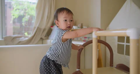 Toddler Learning to Stand Using Play Structure At Home Stock Footage 330739195