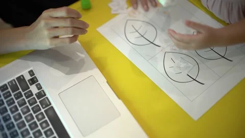 Toddler learning to use glue for her creation Stock Footage 159056214