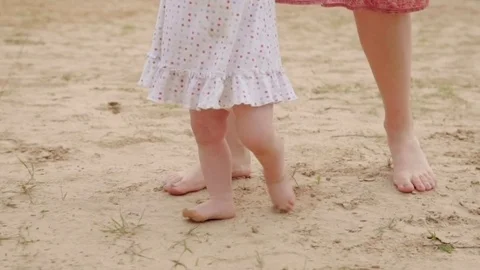 Toddler learning to walk on beach, slow motion Stock Footage 78502237