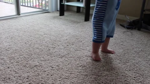Toddler learning to walk on his own Stock Footage 51024077