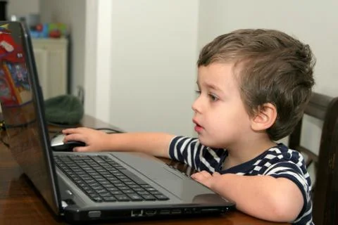 Toddler looking at computer Stock Photos