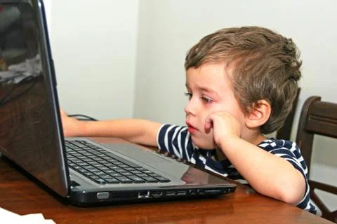 Toddler looking at computer Stock Photos