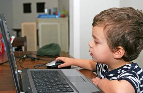 Toddler looking at computer Stock Photos