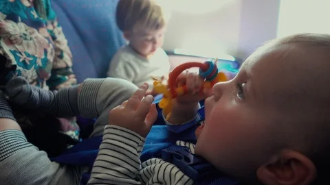 Toddler lying with toy Video stock 111757339