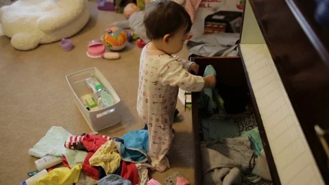 Toddler Making a Mess Pulling Clothes From Dresser Stock Footage 93993206
