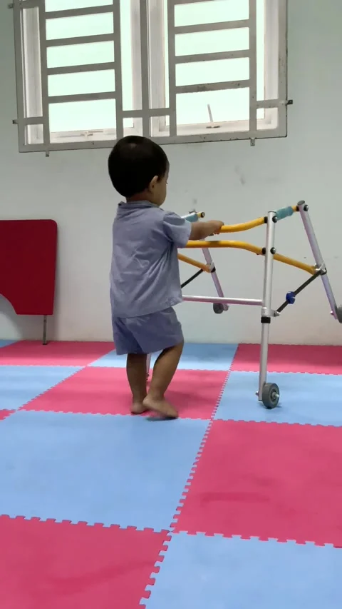 Toddler with Mobility Aid Walking in Therapy Stock-Footage 341498377