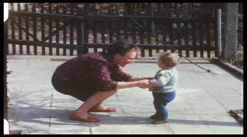 Toddler with mother dancing ring-a-ring-o-roses (vintage 8 mm amateur film) Stock Footage 642437
