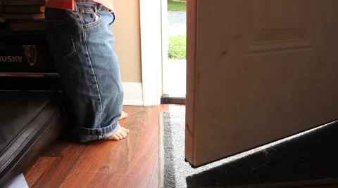 Toddler opens up front door and walks away Stock Footage 44445532