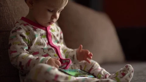 Toddler operates smartphone Stock Footage 73331290