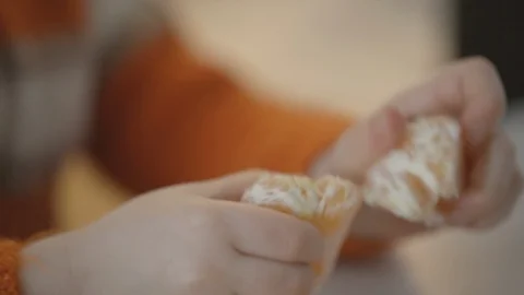 Toddler Peels Orange Stock Footage 103602672
