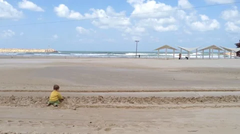 Toddler playing on the beach Stock Footage 52004078