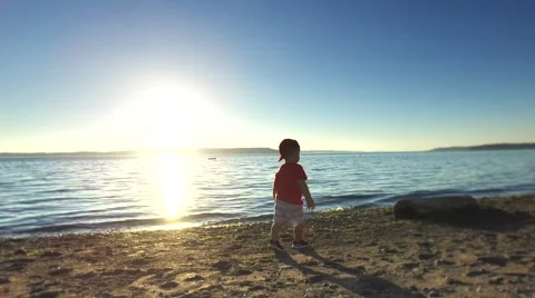 Toddler is playing on the beach Stock Footage 64727203