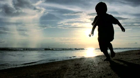 Toddler Playing On Beach At Sunset 動画素材 773232