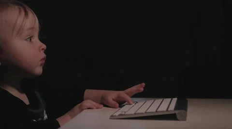Toddler playing with a computer Stock Footage 59126582