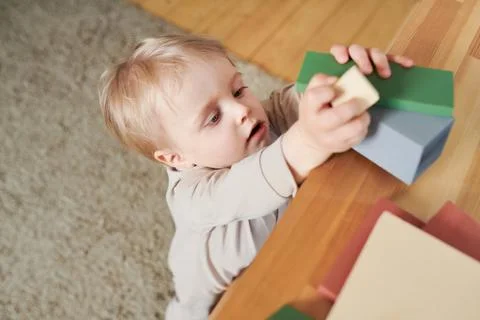 Toddler playing with constructor blocks Stock Photos