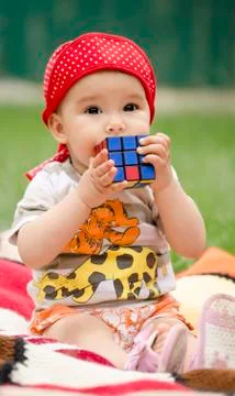 Toddler playing with a cube Stock Photos