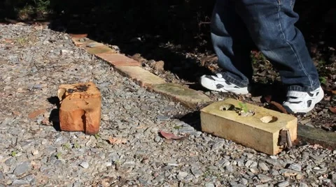 Toddler playing in a drive-way Stock Footage 44447873
