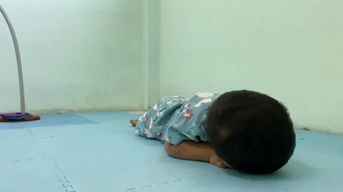 Toddler playing on floor mat in indoor setting Stock Footage 341914360