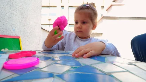 Toddler playing with modeling clay . creative life Stockbeeldmateriaal 129199258