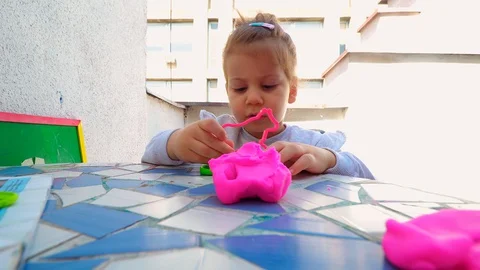 Toddler playing with modeling clay . creative life Stockbeeldmateriaal 129199298