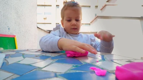 Toddler playing with modeling clay . creative life Stockbeeldmateriaal 129199362