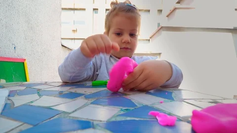 Toddler playing with modeling clay . creative life Stockbeeldmateriaal 129200332