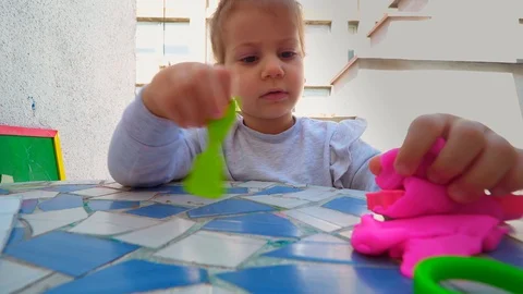 Toddler playing with modeling clay . creative life Stockbeeldmateriaal 129200386