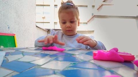 Toddler playing with modeling clay . creative life Stockbeeldmateriaal 129200431