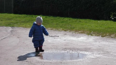 Toddler Playing Puddle Stock Footage 301386932