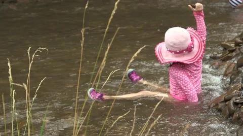 Toddler playing in riverbed 02 Stock Footage 43386619