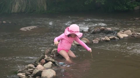 Toddler playing in riverbed Stock Footage 43386621