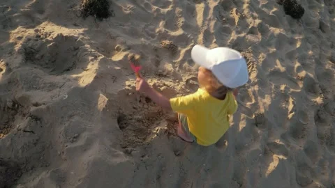 Toddler playing at sand beach Stock Footage 311897614