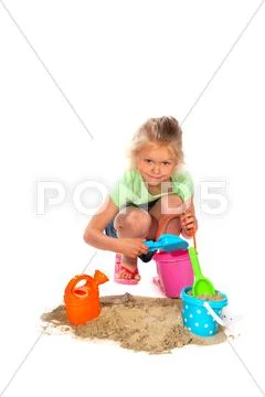 Toddler is playing in the sand Stock Photos