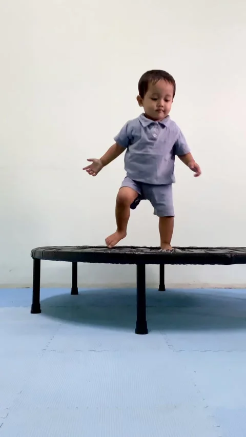 Toddler Playing on Small Indoor Trampoline Stock Footage 341498591