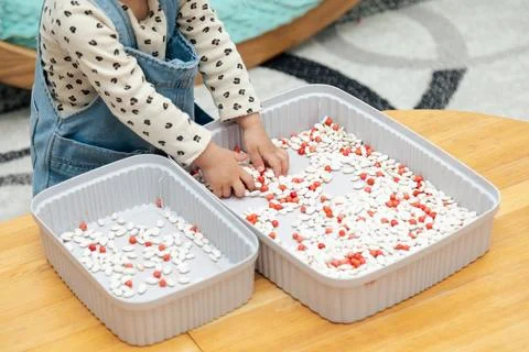 Toddler playing wit beans Stock Photos